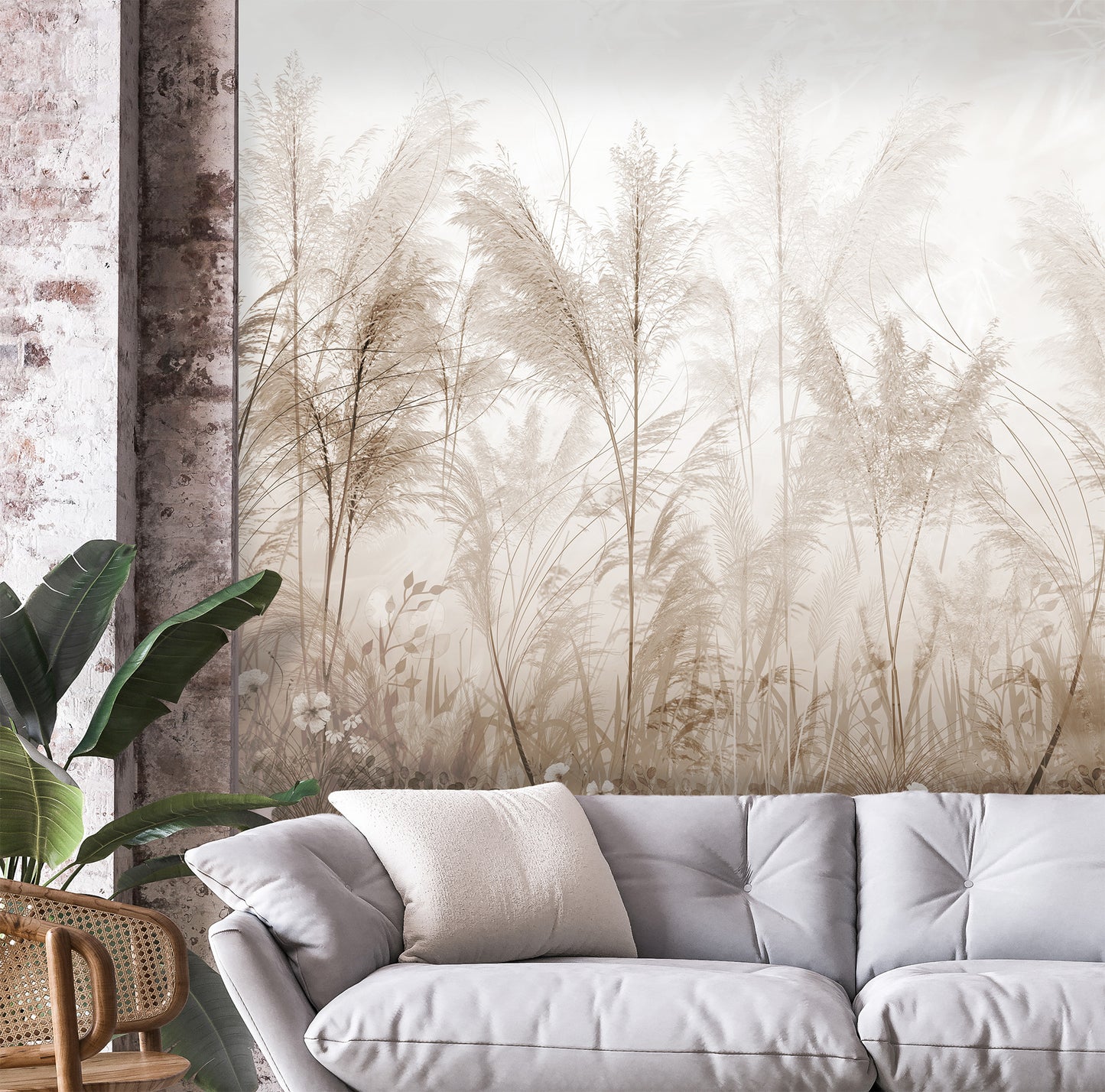 Gray sofa with decorative pillows in a room with a large wall mural of tall grasses.