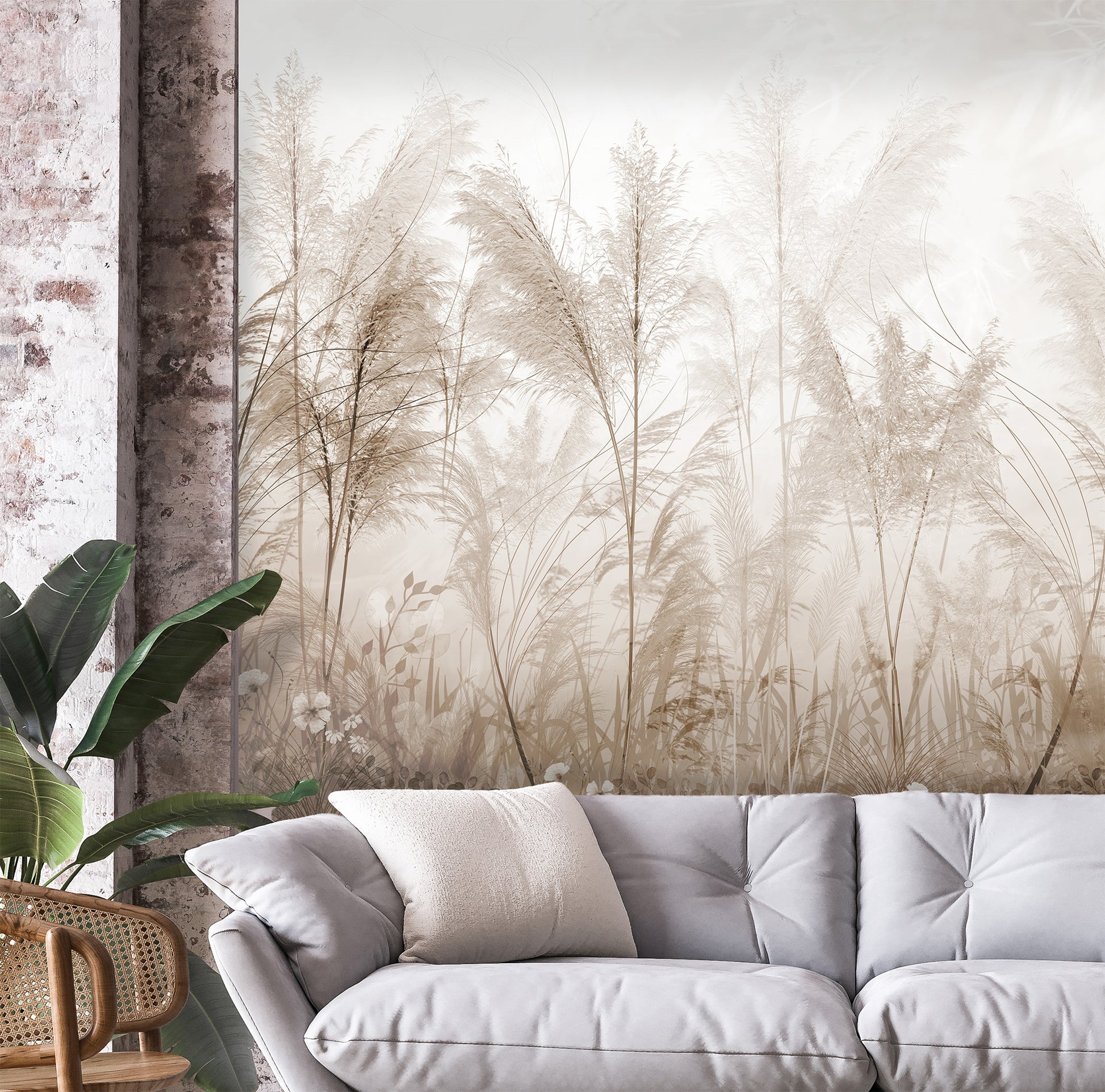 Gray sofa with decorative pillows in a room with a large wall mural of tall grasses.